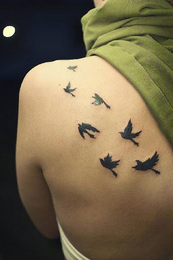 Small Tattoos flying birds tattoos on upper back of women