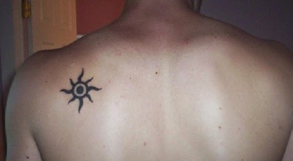 Small Tattoos small tribal sun tattoo on upper back of men