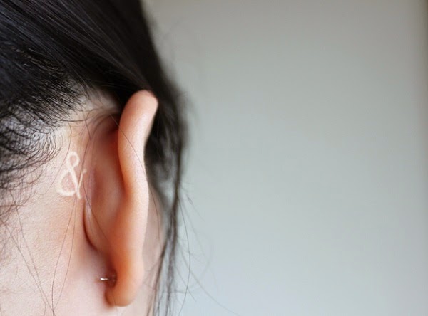 Small Tattoos small music symbol tattoo behind ear