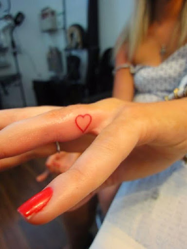 Small Tattoos small red ink heart tattoos on finger