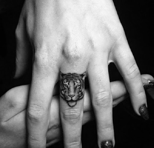 Small Tattoos small tiger face tattoo on finger
