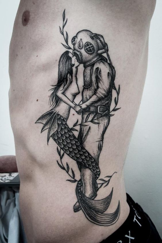 Mermaid kissing scuba diver