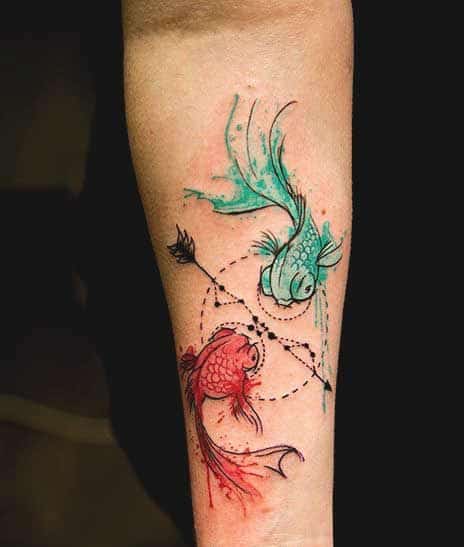 colorful pisces tattoo symbol on arm