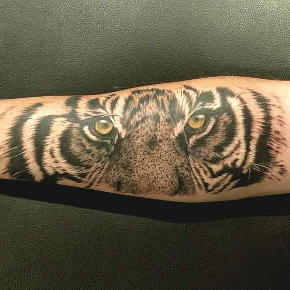 Beautiful tiger face and eyes tattoo on forearm