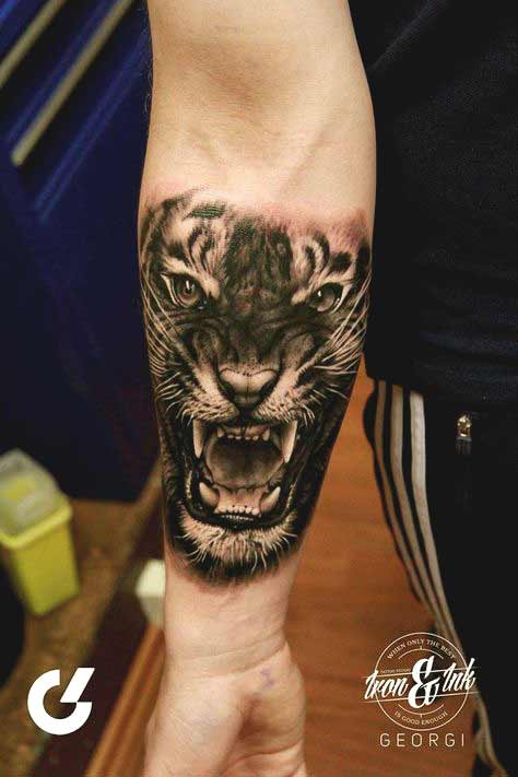 Tiger face tattoo on inner forearm designs for men and women