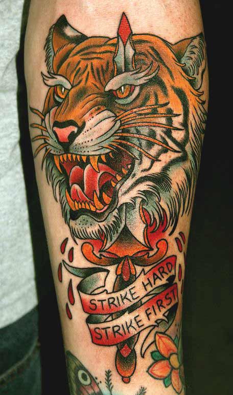 Japanese tiger face tattoo with quote on inner forearm