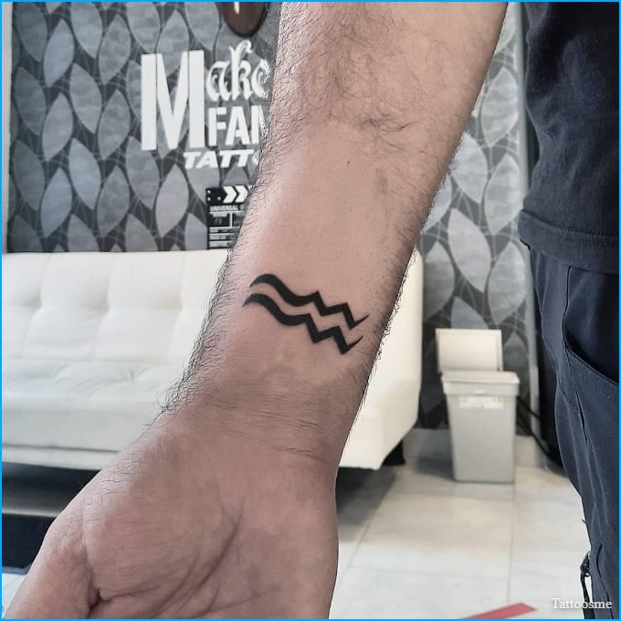 aquarius symbol tattoo on wrist