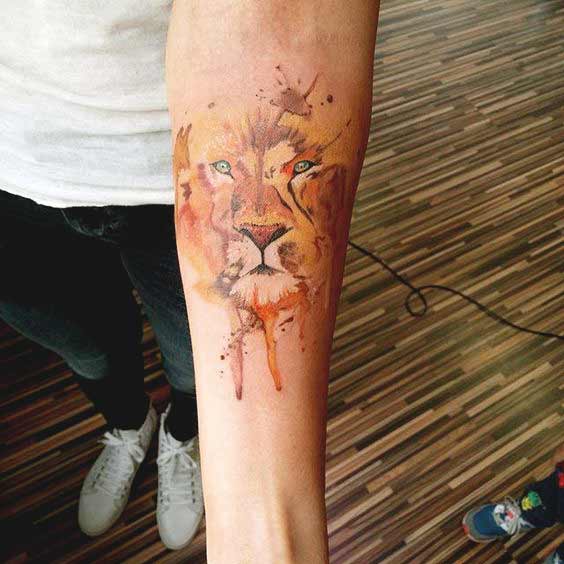 Watercolor lion forearm tattoo