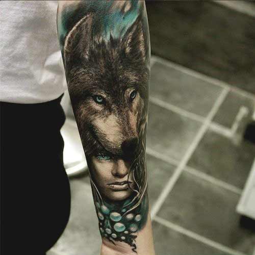 Wolf and girl face tattoo on inner forearm