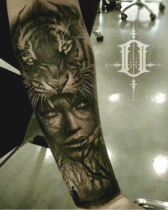 Tiger and face tattoo on inner forearm