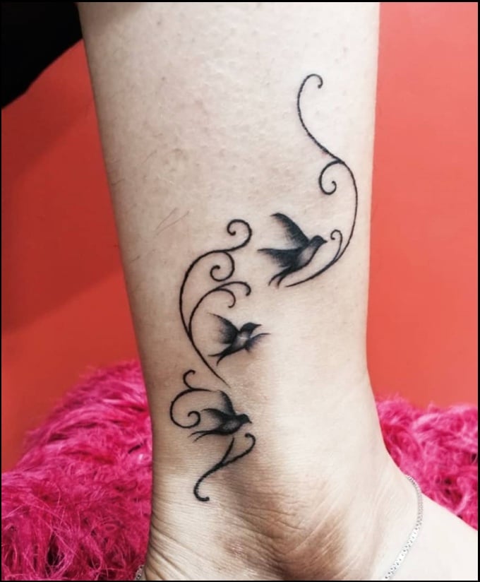 birds with floral ankle tattoos