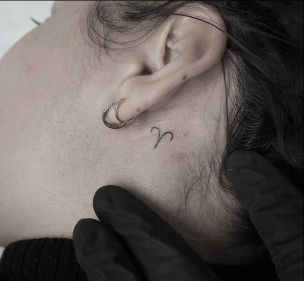 aries symbol tattoo behind ear