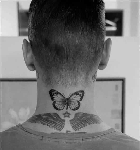 Butterfly tattoo on back of neck for men