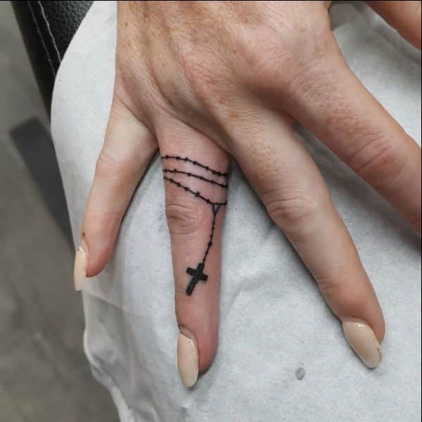 small cross tattoos on fingers