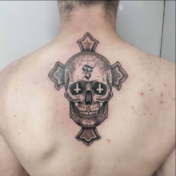cross with skull tattoos on uppe rback