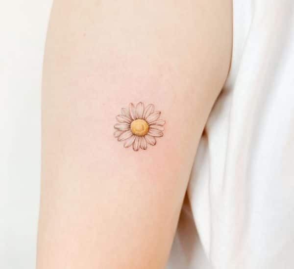 Tiny daisy tattoo on the ankle