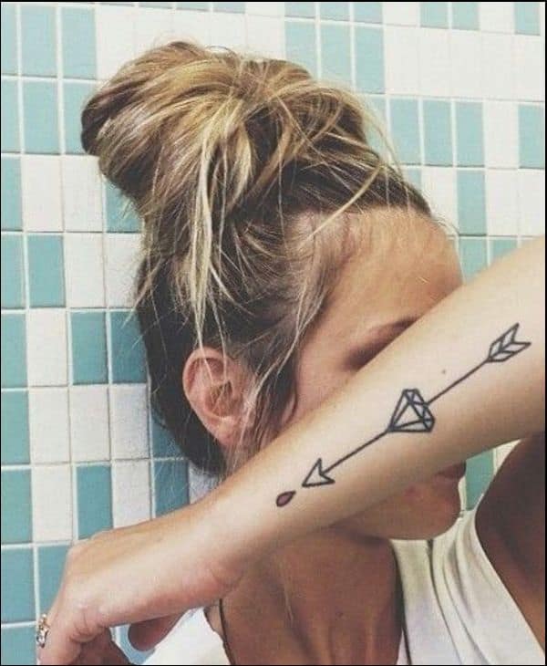 Diamond tattoos with arrow on forearm