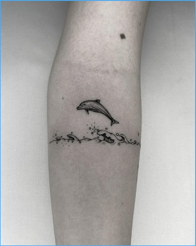 dolphin tattoos with waves