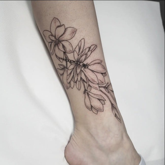 dragonfly tattoo with flowers on legs