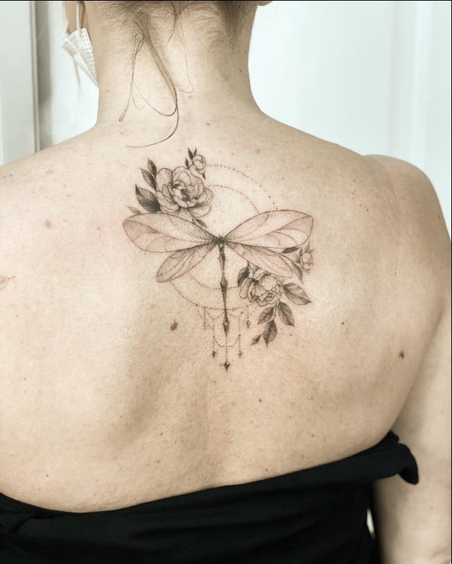 dragonfly tattoo with flowers on back