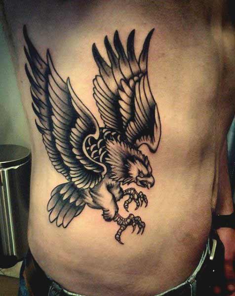 Flying eagle on ribs tattoos