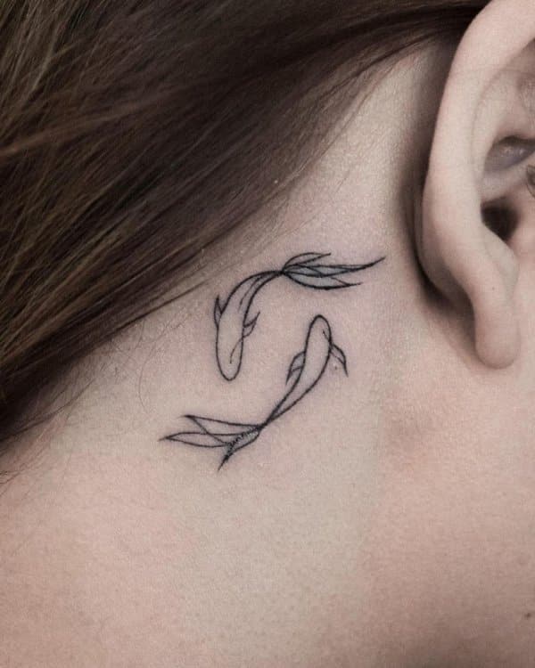 small fish tattoo on ear
