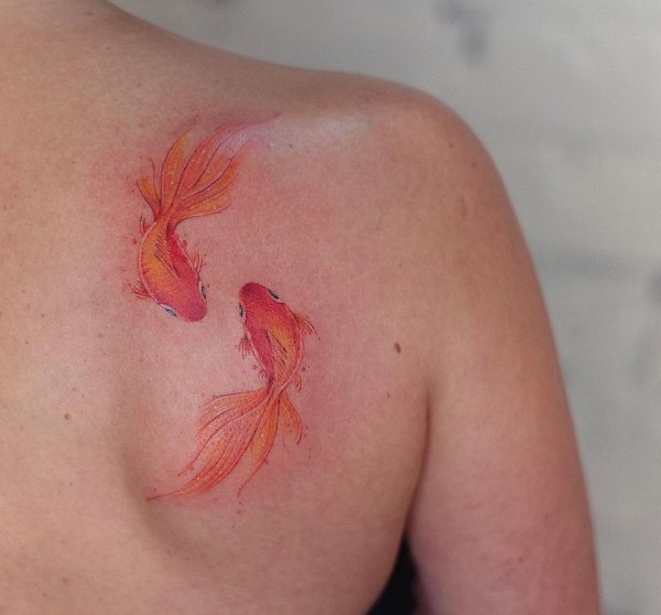 tatuajes de peces en la parte superior de la espalda