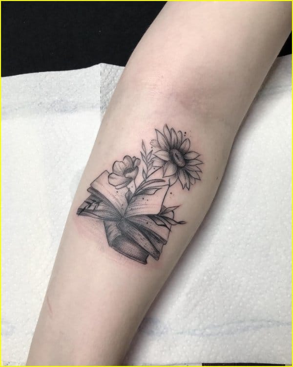 sunflower tattoo with books on arm