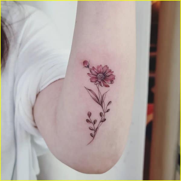daisy flower tattoos on forearms