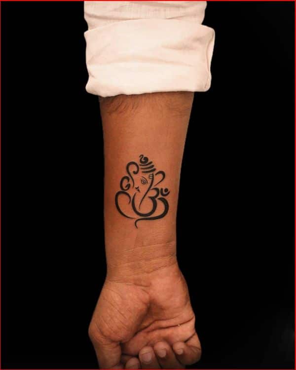 small ganesha tattoo on wrist
