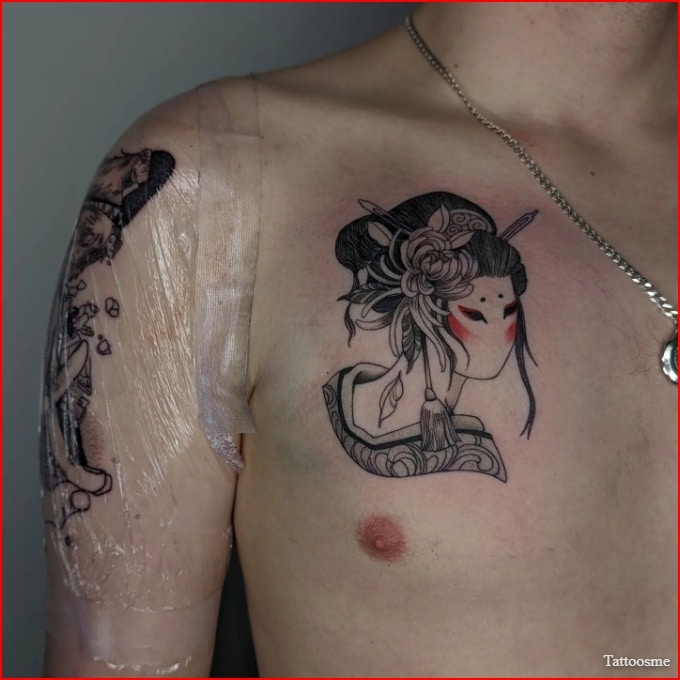Geisha mask tattoo on chest