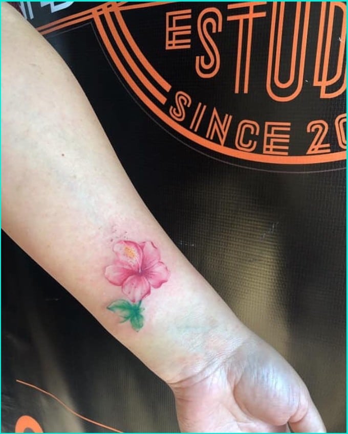 small Hawaiian flower tattoo on wrist