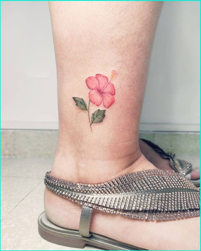 Hawaiian flower tattoo design on anle