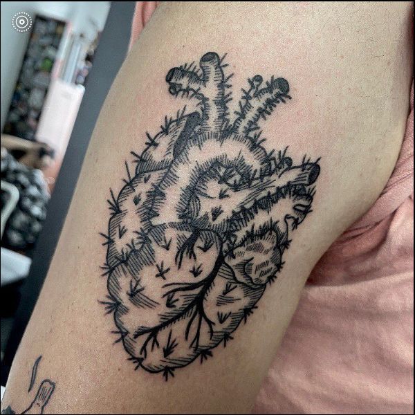 real heart tattoo with thorn