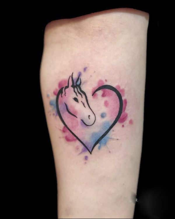 Watercolor heart tattoo on the inner arm.