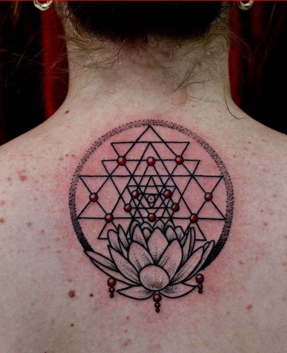 Geometrical style lotus tattoo on back