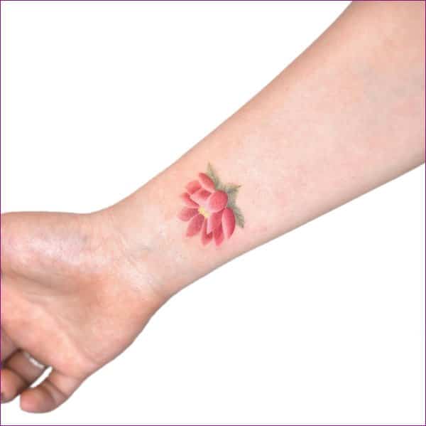 small lotus flower tattoo on wrist