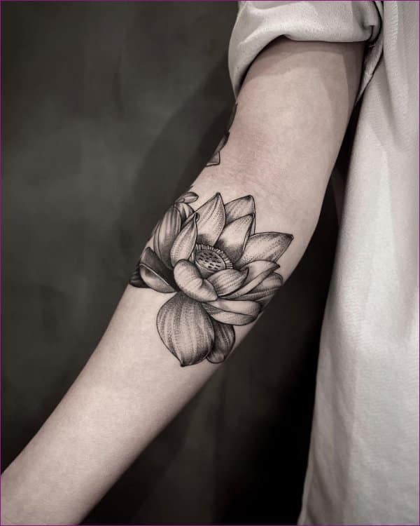 Pink lotus flower tattoo with black and grey elements by Camila  Maui  Tattoo Artist at MidPacific Tattoo  MidPacific Tattoo