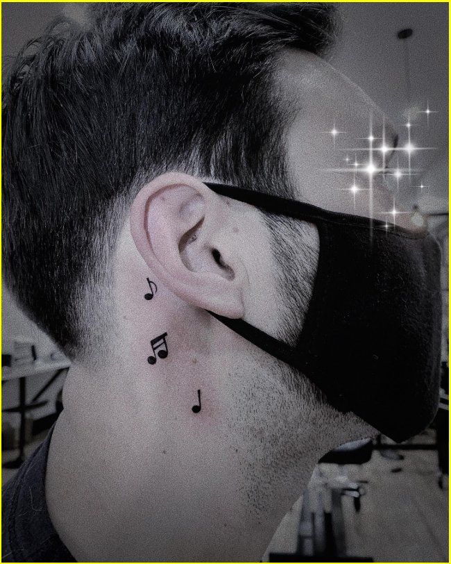 small music tattoo behind the ear