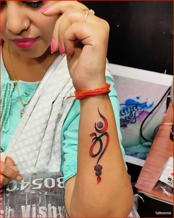 om tattoo design for women's wrist