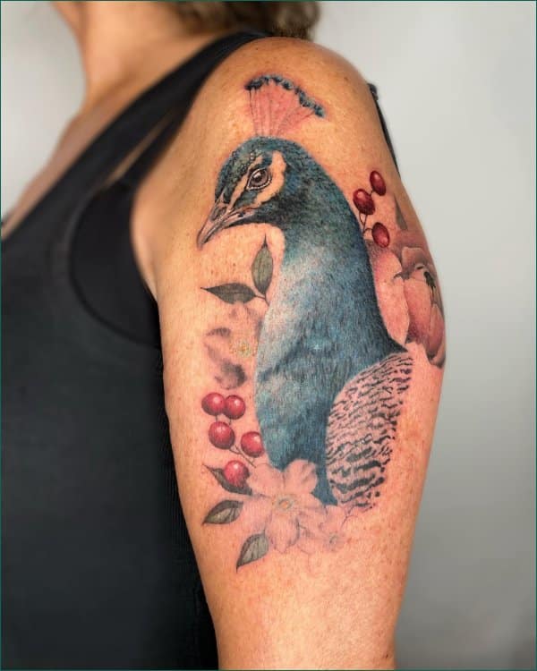 upper arm peacock tattoos