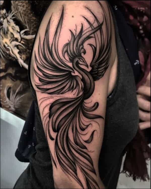 Phoenix tattoo on the right upper arm and shoulder