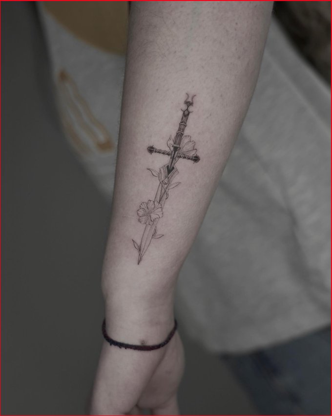 Little sword tattoo located on the inner forearm