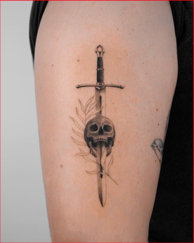 Celtic sword with skull tattoos