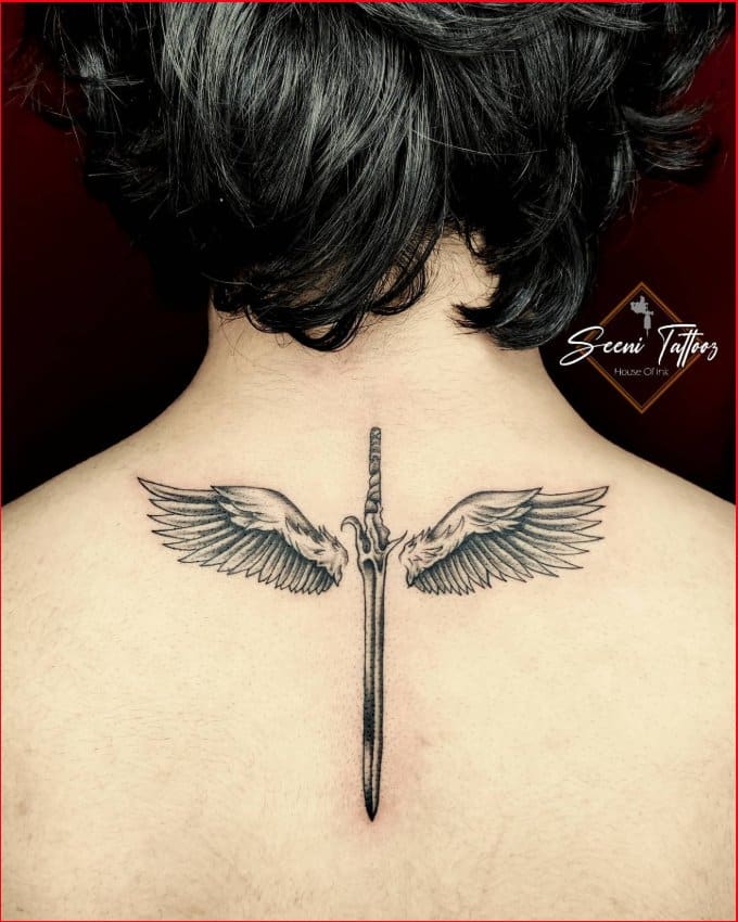 sword tattoo with wings on neck's back