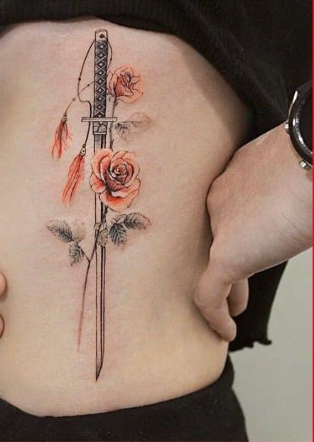 sword tattoo on ribcage