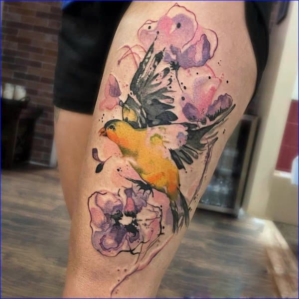 Watercolor bird tattoo on the left inner forearm