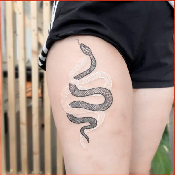 black ink and white ink snake tattoos