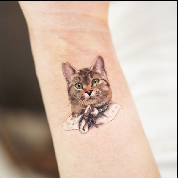 cat tattoo on wrist for girls