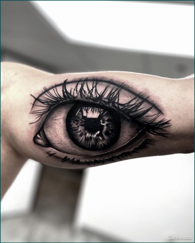 simple eye tattoo on inner bicep